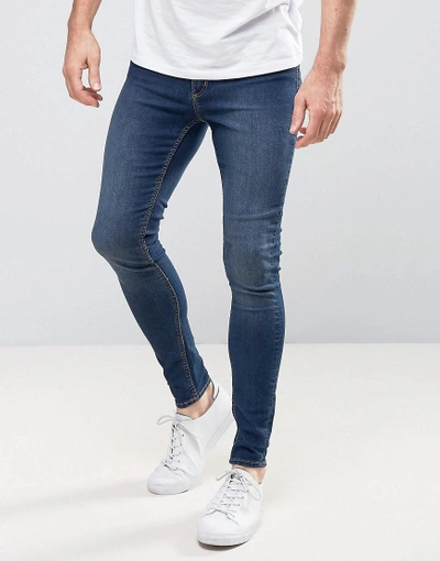 CHEAP MONDAY MID SPRAY JEANS IN DIM BLUE - BLUE