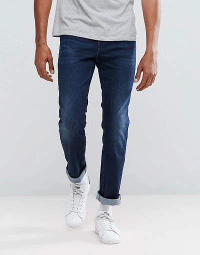 HUGO BOSS BY HUGO BOSS ORANGE 63 SLIM FIT JEANS IN DARK MID WASH - BLUE