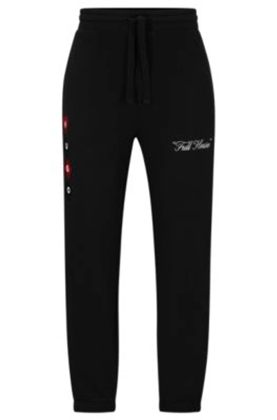 HUGO BOSS COTTON-TERRY TRACKSUIT BOTTOMS WITH PLAYING-CARD ARTWORK