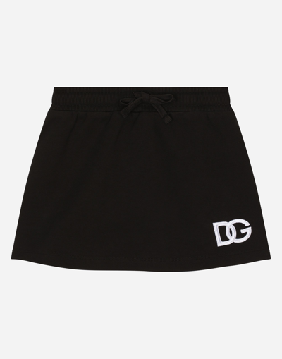 DOLCE & GABBANA SHORT JERSEY SKIRT WITH DG LOGO PATCH