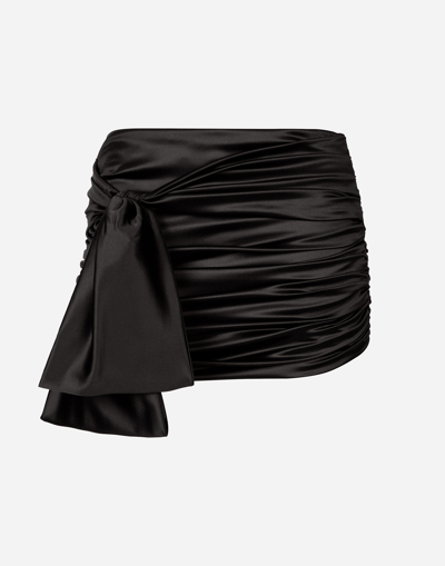 DOLCE & GABBANA SHORT DRAPED SATIN SKIRT WITH SIDE BOW