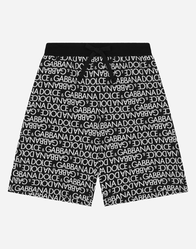 DOLCE & GABBANA COTTON JOGGING SHORTS WITH THE ALL-OVER LOGO PRINT