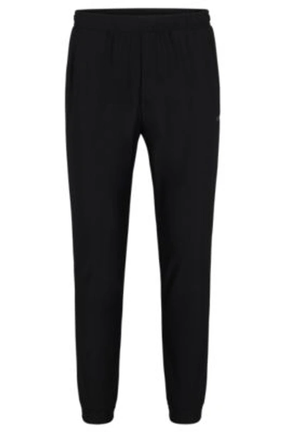 HUGO BOSS TRACKSUIT BOTTOMS IN STRETCH FABRIC WITH DECORATIVE REFLECTIVE LOGO