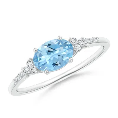 ANGARA HORIZONTALLY SET OVAL AQUAMARINE SOLITAIRE RING WITH TRIO DIAMOND ACCENTS