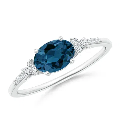 ANGARA HORIZONTALLY SET OVAL LONDON BLUE TOPAZ RING WITH DIAMONDS