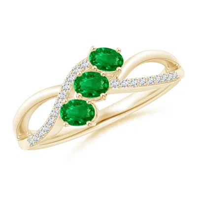 ANGARA OVAL EMERALD THREE STONE BYPASS RING WITH DIAMONDS