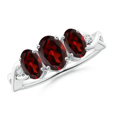 ANGARA OVAL GARNET THREE STONE CRISS-CROSS RING