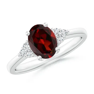 ANGARA SOLITAIRE OVAL GARNET RING WITH TRIO DIAMOND ACCENTS
