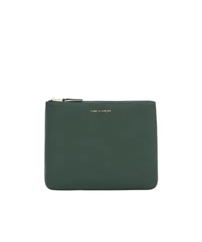 COMME DES GARÇONS COMME DES GARONS WALLET LOGO PRINTED ZIPPED POUCH