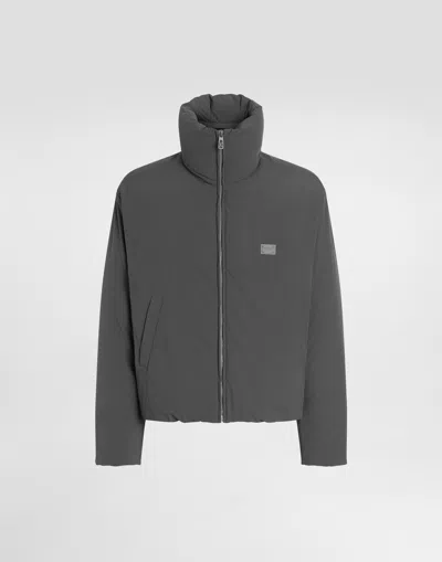 DOLCE & GABBANA PADDED TECHNICAL FABRIC JACKET WITH A HIGH NECK AND TAG