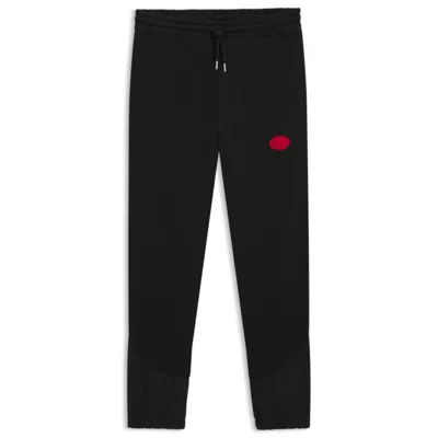 HUGO BOSS COTTON-BLEND TRACKSUIT BOTTOMS WITH WAXED-STAMP LOGO