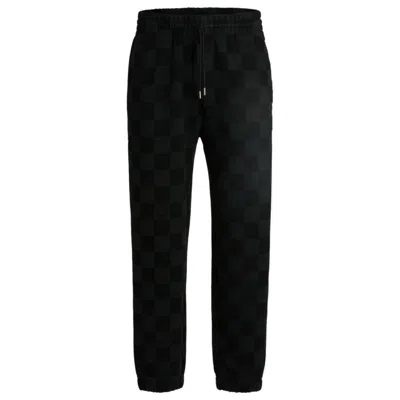 HUGO BOSS LOOSE-FIT TRACKSUIT BOTTOMS WITH CHECKERBOARD PRINT