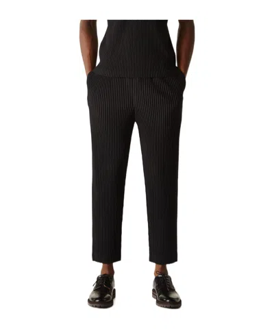ISSEY MIYAKE HOMME PLISSÉ ISSEY MIYAKE PLEATED TAPERED LEG PANTS
