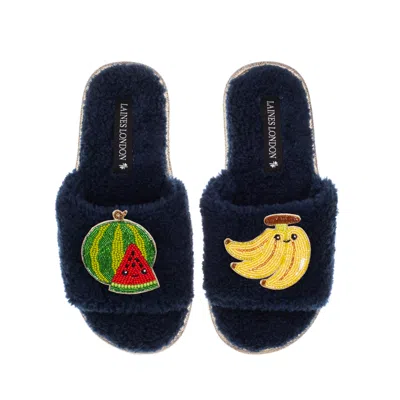 LAINES LONDON WOMEN'S BLUE TEDDY SLIDER SLIPPERS WITH LAINES LOVABLES WATERMELON & BANANA BROOCHES - NAVY