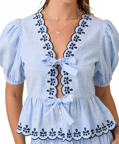 MAIN STRIP DEENA V-NECK PEPLUM BLOUSE WITH SCALLOP EDGES IN LIGHT BLUE