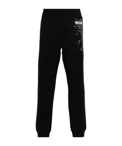 MOSCHINO MOSCHINO LOGO-PRINTED TROUSERS