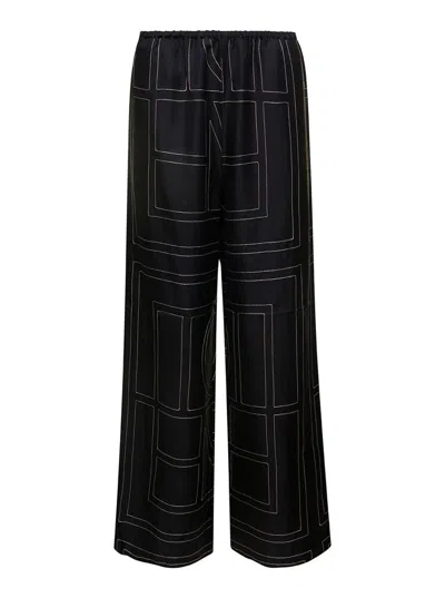 TOTÊME BLACK LOOSE PANTS WITH MONOGRAM PRINT IN SILK WOMAN