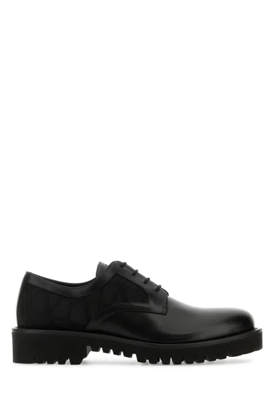 VALENTINO GARAVANI BLACK LEATHER AND TOLIE ICONOGRAPHE LACE-UP SHOES